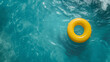 Yellow ball swimming in blue pool water, holiday concept summer vacation
