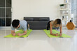© plo - Young Asian Couple Workout at Home by Doing Plank