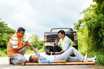 Closeup rescue workers using radio communication helping woman driver from car accident on road.