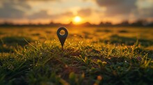 Gleaming Location Marker In An Open Green Field At Sunset