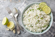 Organic cilantro lime rice with garlic and zest close-up in a bowl on the table. Horizontal top view from above