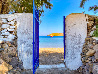 Wall Mural - Open gateway to Meloi beach with view of docked red sailing boat