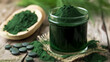 Nutrient-rich Spirulina in the form of powder and tablets on a wooden board
