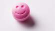 Pink medicine pill with embossed happy smiley