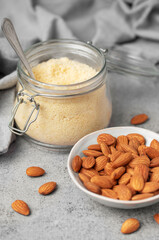 Wall Mural - Fresh almond flour in a  glass jar and almonds