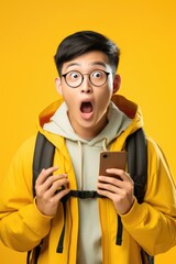 Poster - A man wearing a yellow jacket holding a cell phone. Suitable for technology and communication concepts