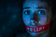 Crying woman in a dark room with her mouth covered with red tape and the inscription Help