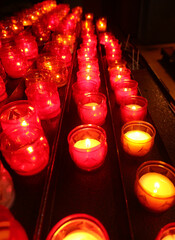 votive red candles lit during the religious rite inside the place of worship