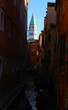 glimpse of the bell tower of Saint Mark also called SAN MARCO CAMPANILE in Venice and the navigable canal