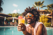 Man with afro hairstyle toasting with cocktail on a pool