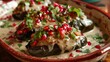 Mexican chiles en nogada stuffed with picadillo, topped with walnut cream sauce, pomegranate seeds, and parsley