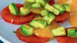 Healthy fresh salad with avocado, orange on plate. Homemade delicious lunch testy salad for restaurant, menu, advert or package, close up selective focus