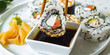 Sushi Roll Platter on white plate. Salmon sushi set, serving food for restaurant, menu, advert or package, close up, selective focus