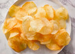 Potato Chips Crinkle Snack on plate. Homemade potato chips for restaurant, menu, advert or package, close up, selective focus