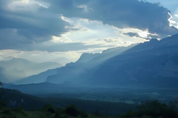 Aufkleber - A breathtaking landscape emerges as the sun pierces through the clouds, revealing a highland valley adorned with misty mountains, lush hills, and towering trees