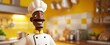 Personnage cartoon d'un chef cuisinier noir, souriant, cuisine en arrière-plan.