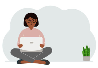 A woman sits cross-legged in his hands holding a laptop. The concept of work, education, reading, watching videos.