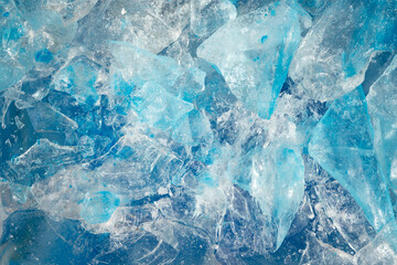 broken ice close up. pieces of crushed blue ice cracks background texture. close-up frozen water.