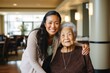 © Baba Images - Portrait of a senior woman with a caregiver in nursing home