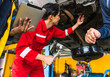 Japanese mechanic man fixing car in auto repair garage
