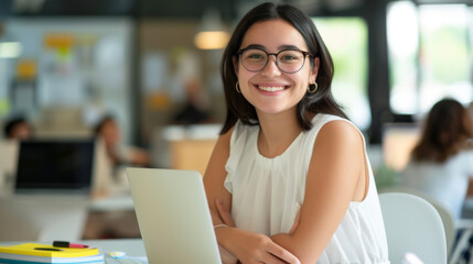 Wall Mural - cheerful woman , wearing a white blouse and a necklace, smiling and looking at a laptop screen