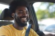 © Julia Jones - Happy man driving a car wearing a yellow t-shirt.