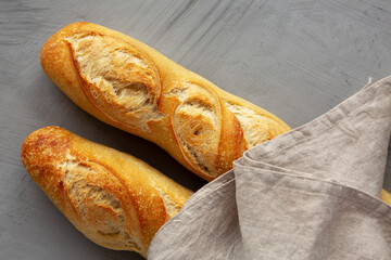 Wall Mural - Homemade French Bread Baguette on a gray background, top view.