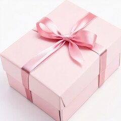 Small elegant gift box with a pink ribbon placed on a white surface