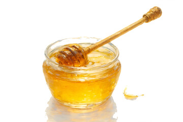Wall Mural - Honey dripping from a glass jar