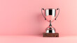 © Shi  - Silver champion cup, winners trophy on a victory podium on pink background with copy space. Business reward concept. Generative AI