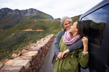 Canvas Print - Happy couple, hug and road trip with love for holiday, weekend or bonding together by car in nature. Young man and woman with smile enjoying romance in support, trust for outdoor vacation by vehicle