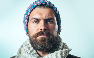 Sticker - Male autumn-winter fashion. Portrait of stylish handsome guy in fashionable warm clothing. Attractive man with beard and mustache in woolen hat and scarf. Serious bearded man in knitted hat and scarf.