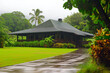 Picturesque Hawaiian Plantation-Style House on a Rainy Day Surrounded by Lush Greenery