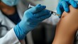 A healthcare worker in blue gloves carefully administering a vaccination shot to a patient, emphasizing the importance of immunization.