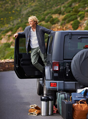 Poster - Man, car and looking out door on road trip for travel, break or stop in nature or sightseeing. Young or handsome male person, tourist or traveler exploring or enjoying view or holiday from vehicle