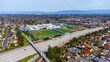 Aerial view of a high school grounds in residential neighborhood near Don Burnett bicycle pedestrian a cable-stayed bridge over Interstate 280, spanning Cupertino and Sunnyvale, California