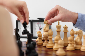 Poster - Father and son playing chess at table indoors, closeup