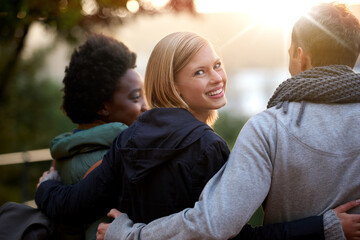 Wall Mural - University, friends and portrait with hug or happy for bonding, relax and break on campus with diversity. College, people and smile with embrace for support, education and learning fun with rear view