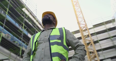 Poster - Black man, architect and inspection on construction site for building, industrial architecture or management. African male person, contractor or civil engineer checking concrete structure and safety