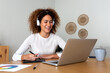 © Daniel - Multiracial happy female graphic designer working at home using laptop and graphic tablet.
