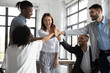 Leinwandbild Motiv Well done. Dedicated company workers high-fiving each other to celebrate success. Business coach motivating employees for excellent work, boosting optimistic attitude, creating positive atmosphere at