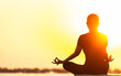 © tonjung - Yoga silhouette woman on the ocean during amazing sunset. Fitness and healthy lifestyle.