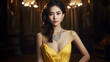 © Anna Iluschenko - Portrait of an elegant Asian woman in a yellow evening dress with a plunging neckline and jewelry made of precious stones. Luxurious Asian woman with evening make-up on bokeh background