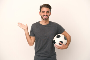 Young football player woman isolated on white background with shocked facial expression