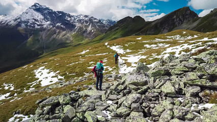 aerial view of hiker couple on alpine meadow looking at majestic mount vorderer geisslkopf in high t