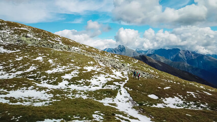 Wall Mural - Aerial view of hiker couple on rough alpine terrain in High Tauern National Park, Carinthia, Austria. Idyllic hiking trail Austrian Alps. Wanderlust paradise. Sense of exploration. Escape in nature