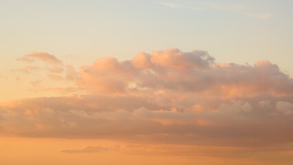 Wall Mural - As the sun sets, the sky transforms into a breathtaking display of majestic clouds.