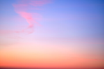 Wall Mural - Clear transparent cirrus clouds on a red sunset sky