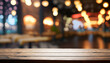 © Uuganbayar - Empty dark wooden table in front of restaurant abstract blurred bokeh background. Can be used to display or mount your products. Mockup for empty space