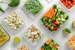 chopped fresh vegetables and ingredients for a healthy diet in plastic containers on a white background